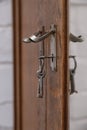 Old vintage metal keys inserted into the cabinet door. Vintage antiques concept