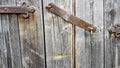 Old vintage metal padlock on a closed wooden door of an old farmhouse. The true style of the village. close-up. focus on the Royalty Free Stock Photo