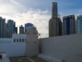 Old vintage Middle Eastern building  and towers surrounded by modern skyscrapers - Qasr Al Hosn in Abu Dhabi city Royalty Free Stock Photo