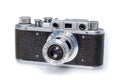 Old vintage 35mm film photo camera isolated on white background. Royalty Free Stock Photo
