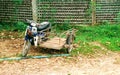 Old vintage motorbike with wooden carrier in a rural Thai village