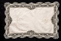 Old vintage napkin with lace border on the black wooden table Royalty Free Stock Photo