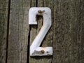 Old vintage number two door plate on old wooden fence Royalty Free Stock Photo