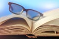 Old vintage opened book with glasses Royalty Free Stock Photo