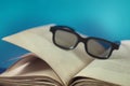 Old vintage opened book with glasses Royalty Free Stock Photo