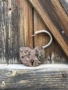 Old vintage padlock. Against the background of an old wooden shed.