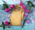 Old vintage paper, pen with quill, vintage keys, pink peony rose flowers on blue background. Love letter