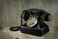 Old vintage phone with rotary disc on wooden table grunge background Royalty Free Stock Photo