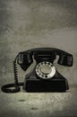 Old vintage phone with rotary disc on wooden table grunge background Royalty Free Stock Photo