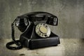 Old vintage phone with rotary disc on wooden table grunge background Royalty Free Stock Photo