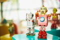 Old vintage pink robot toy on a color blurry background. Royalty Free Stock Photo