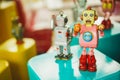 Old vintage pink robot toy on a color blurry background. Royalty Free Stock Photo