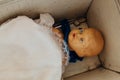 Old vintage plastic doll toy in cot little bed