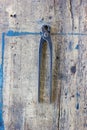 Old vintage pliers pincers against. wooden plank. Royalty Free Stock Photo