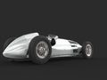 Old vintage race car in metallic silver color - back view