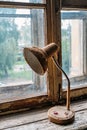 Old vintage reading lamp coiled with a string on old window sill Royalty Free Stock Photo