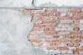 Old vintage red brick wall with gray stucco texture background
