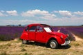 Old vintage red car parked near lavender field