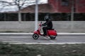 Old vintage and red motorbike is moving on the road