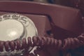 Old vintage red rotary dial phone close up toned sinister creepy colors, halloween and horror concept Royalty Free Stock Photo