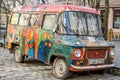 Old vintage retro abandoned car painted graffiti artists in the hippy style is broken on one of the streets of Lviv Royalty Free Stock Photo