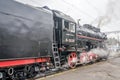 Old vintage retro black locomotive with red star arrived at the station where he was photographed passengers and tourists Royalty Free Stock Photo