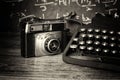 Old vintage retro camera with old-fashioned typewriter Royalty Free Stock Photo