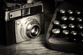 Old vintage retro camera with old-fashioned typewriter Royalty Free Stock Photo