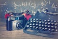 Old vintage retro camera with old-fashioned typewriter Royalty Free Stock Photo