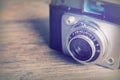 Old vintage retro camera on wooden background Royalty Free Stock Photo