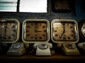 Old vintage retro clocks and phones in dark atmosphere