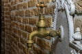 Old vintage retro copper water tap in a brick wall Royalty Free Stock Photo