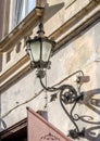 Old vintage retro lamp black classic look on the wall of a house on one of the streets of Lviv Royalty Free Stock Photo