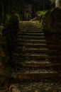 Old vintage retro staircase from paving stones with fallen leaves in an antique park on an autumn night