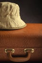 Old vintage, retro suitcase and panama hat on dark background. Travel concept Royalty Free Stock Photo