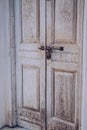 Old vintage wooden door and retro metal locking handle lock