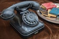 Old vintage rotary dial black telephone on brown velvet Royalty Free Stock Photo