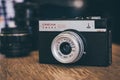 Old vintage Russian film camera on wooden table, model Lomo Smena 8