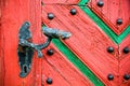 Old vintage and rusted door handle on old cracked grunge wooden door.