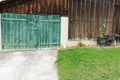 Old vintage rustic green wooden barn door on a wooden shed Royalty Free Stock Photo