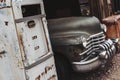 Old vintage rusty car truck abandoned in the abandoned gas station. Royalty Free Stock Photo
