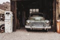 Old vintage rusty car truck abandoned in the abandoned gas station. Royalty Free Stock Photo