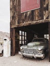 Old vintage rusty car truck abandoned in the abandoned gas station. Royalty Free Stock Photo