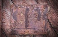 Old vintage rusty metal plate on wooden board. Empty template. Tex space. Royalty Free Stock Photo