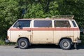 an old vintage rusty minibus standing in the yard. hippie culture