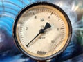 Old vintage rusty psi bar pressure measurement gauge installed on hydraulic equipment Royalty Free Stock Photo