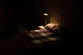 Old vintage single bed at night . A realistic dollhouse bedroom with furniture and window