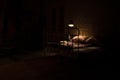 Old vintage single bed at night . A realistic dollhouse bedroom with furniture and window