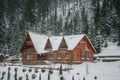 Old vintage snowy wooden house. Winter. Mountains and forest Royalty Free Stock Photo