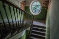 Old vintage staircase at the old house. Oval window